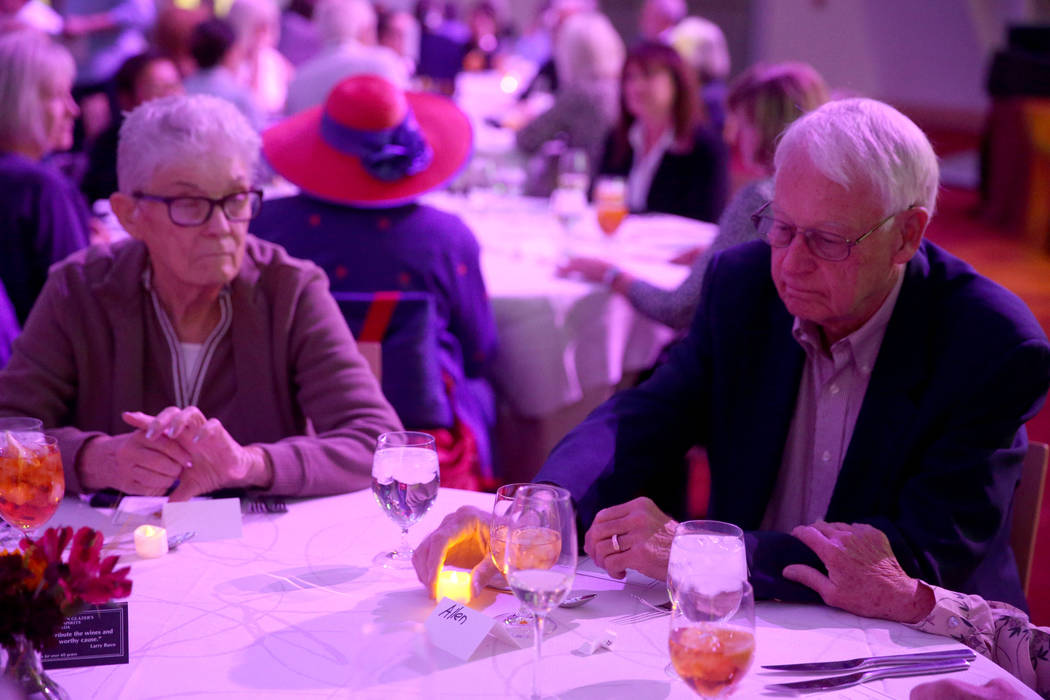 Allen Duke of Las Vegas lights an electronic candle for a loved one during Death Over Dinner - ...