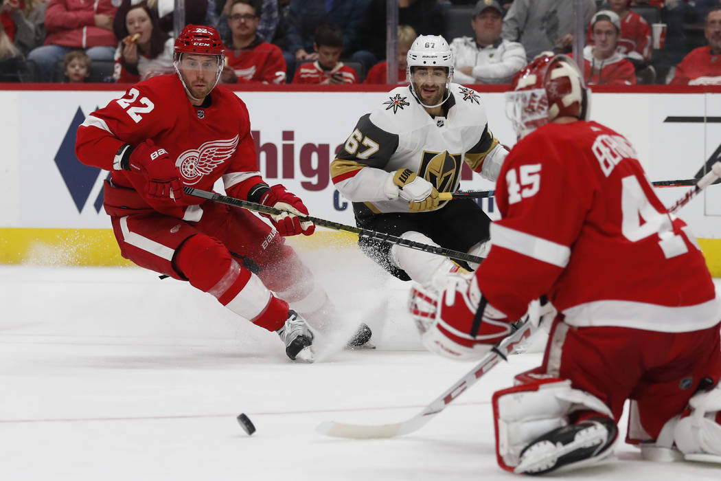 Detroit Red Wings goaltender Jonathan Bernier (45) deflects a shot as defenseman Patrik Nemeth ...