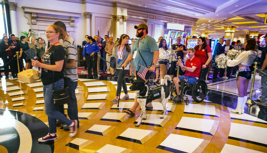 Wounded veterans and family members enter the Grand Colonnade during a 'Salute Our Troops' cere ...