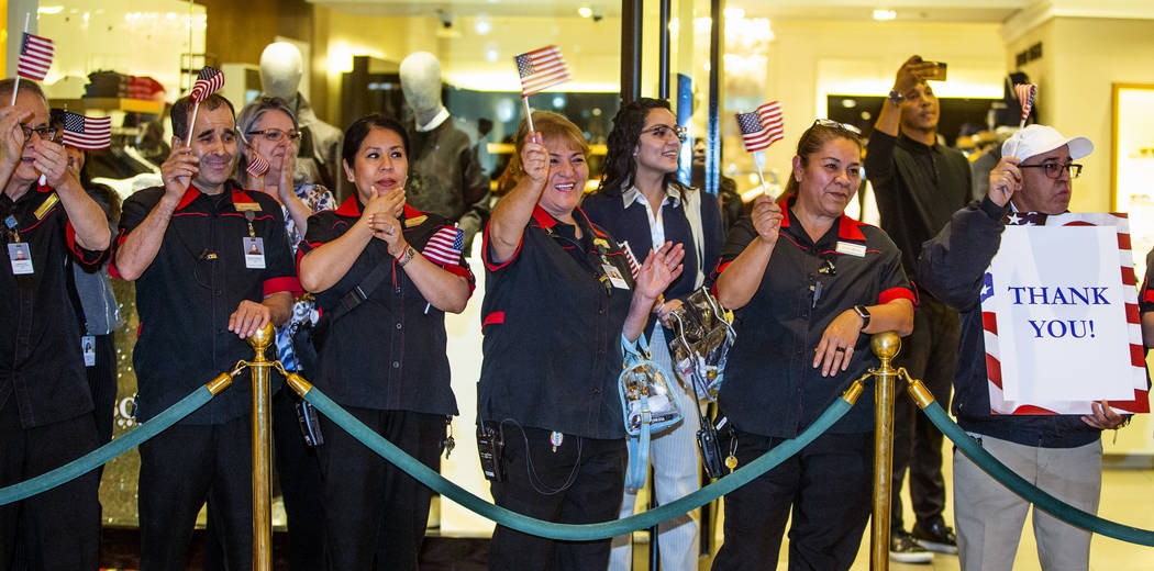 Employees from The Venetian gather to applaud as wounded veterans and family members enter the ...
