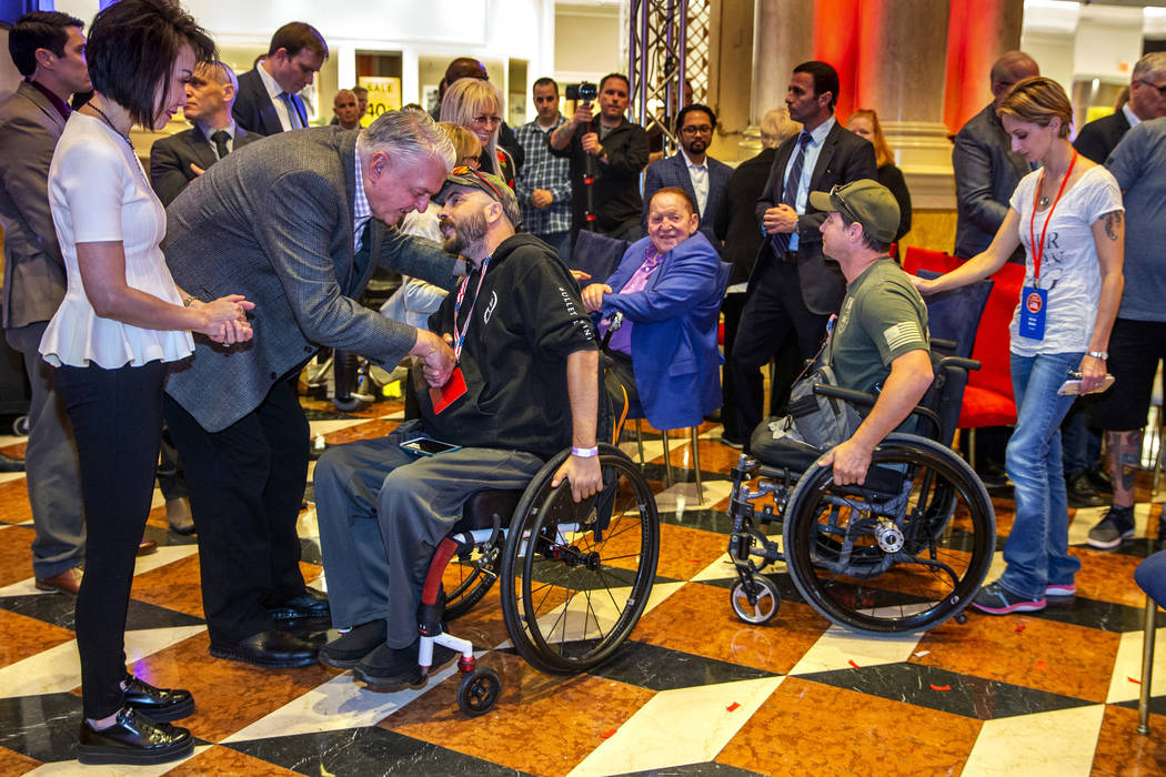 Gov. Steve Sisolak with his wife, Kathy, with Sheldon and Miriam Adelson thank wounded veterans ...