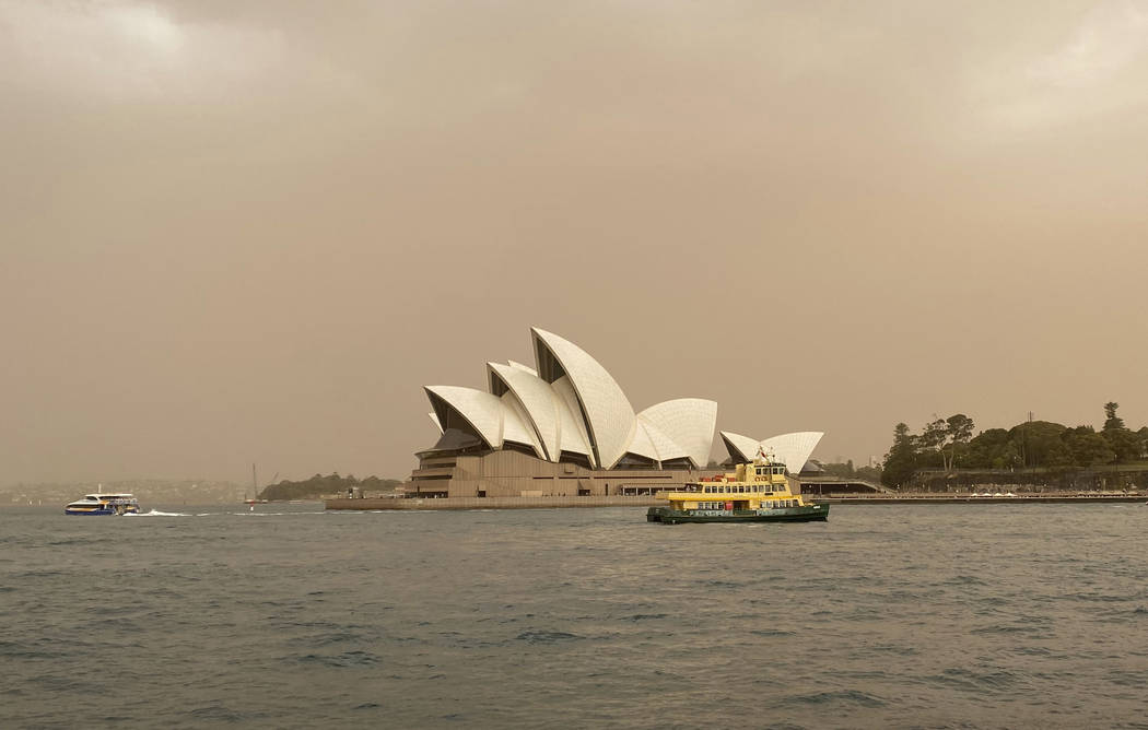 Sydney Opera House is backdropped by haze from wildfires near the city, in Sydney, Australia, T ...
