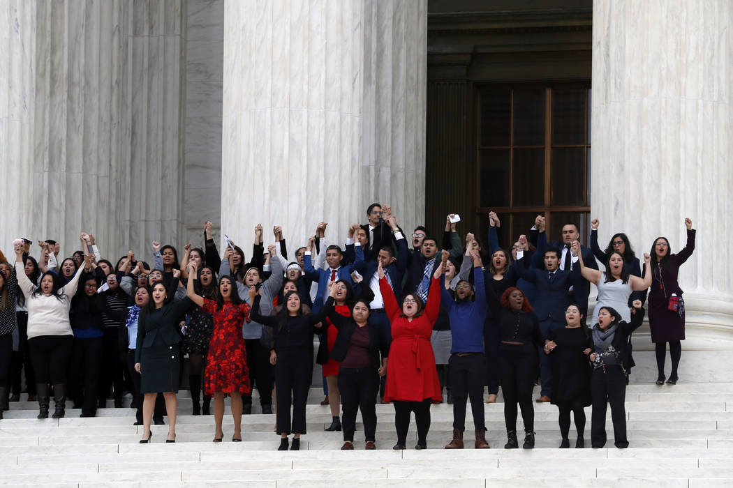 DACA recipients and others leave the Supreme Court with their hands in the air after oral argum ...