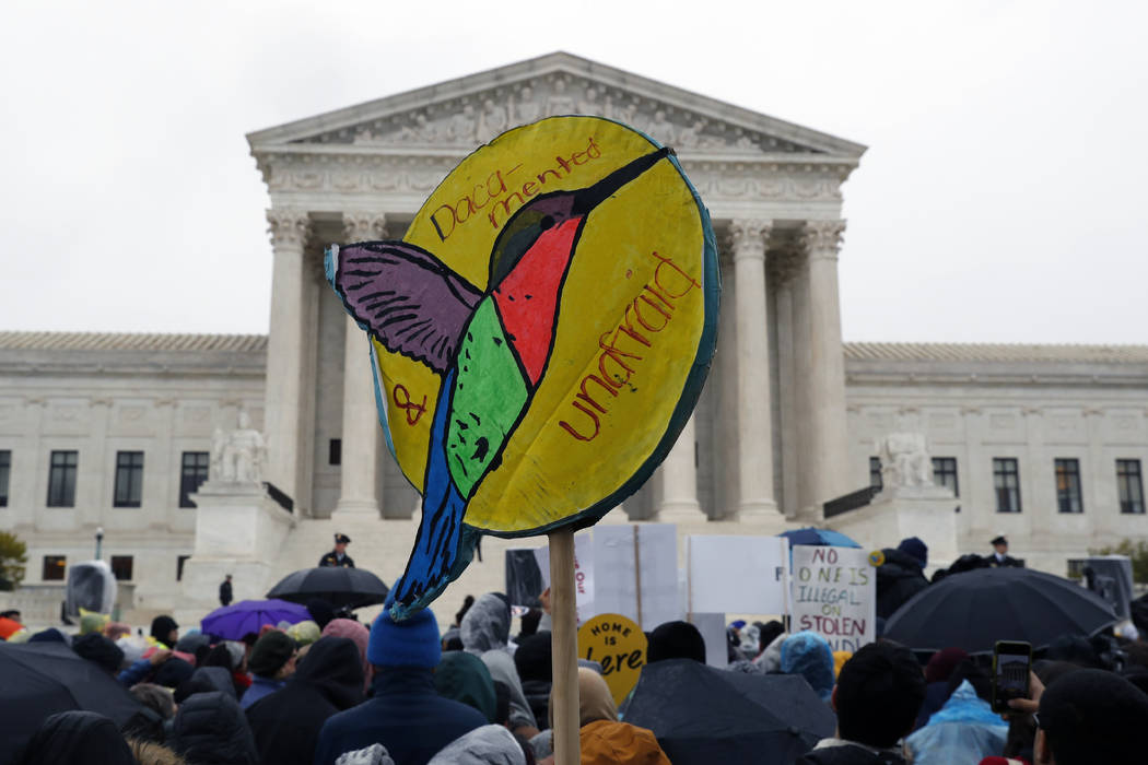 People rally outside the Supreme Court as oral arguments are heard in the case of President Tru ...