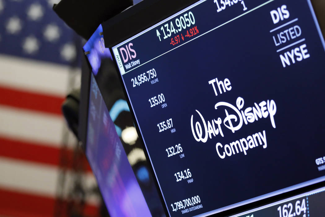 The logo for The Walt Disney Company appears above a trading post on the floor of the New York ...