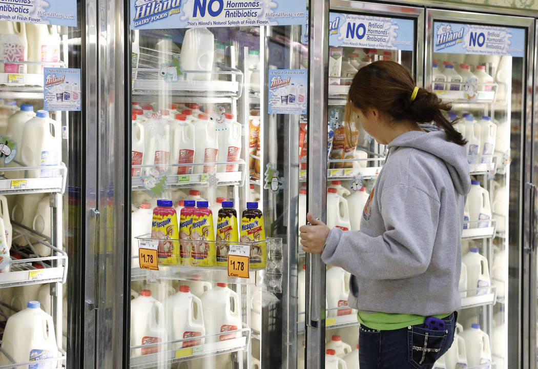 FILE - In this Dec. 4, 2013, file photo Jessica Walton, of Guthrie, Okla., reaches for a contai ...