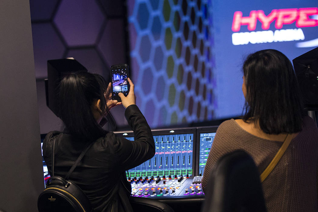 Grant recipient Obe Wan takes a picture while exploring the production room during a visit to t ...