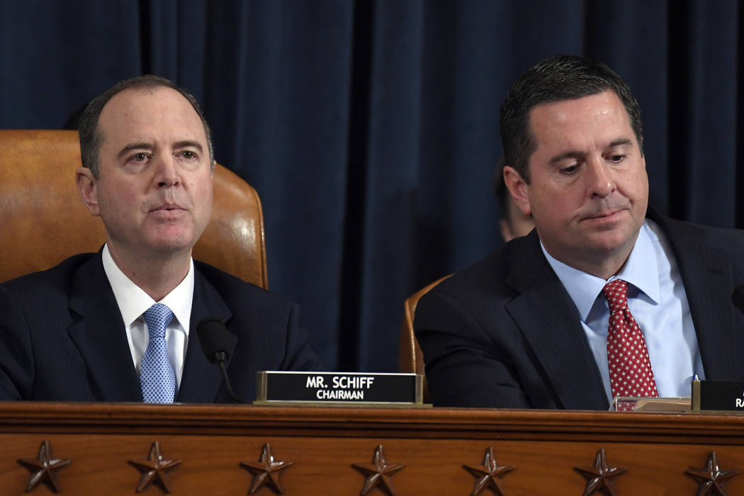 House Intelligence Committee Chairman Adam Schiff of Calif., left, speaks as Rep. Devin Nunes, ...