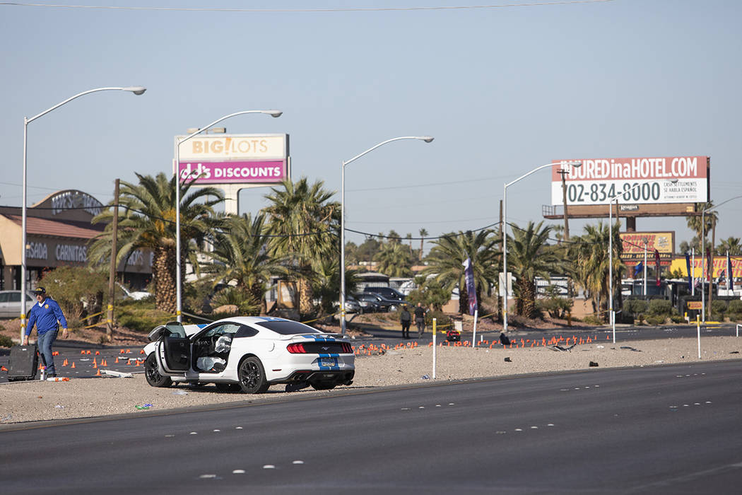 Police work around a vehicle involved in a suspected DUI crash that occurred early in the morni ...