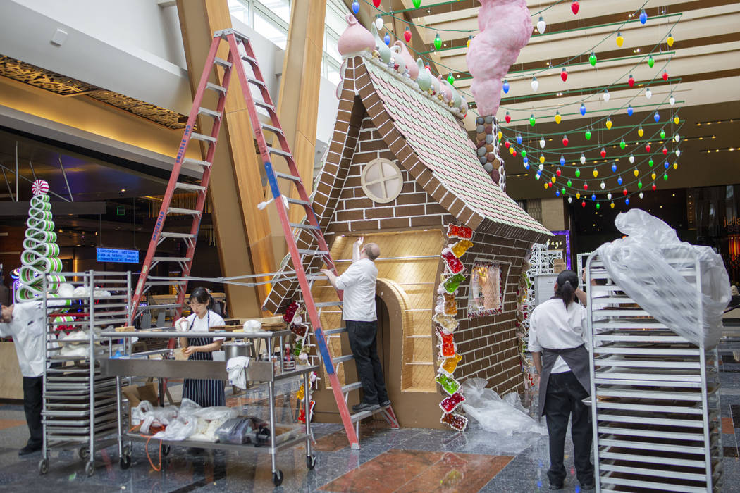 Aria Patisserie pastry chefs work on a giant gingerbread house in the lobby of the Aria resort- ...