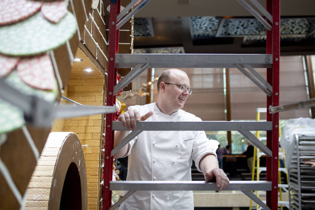 Aria Patisserie pastry chefs work on a giant gingerbread house in the lobby of the Aria resort- ...