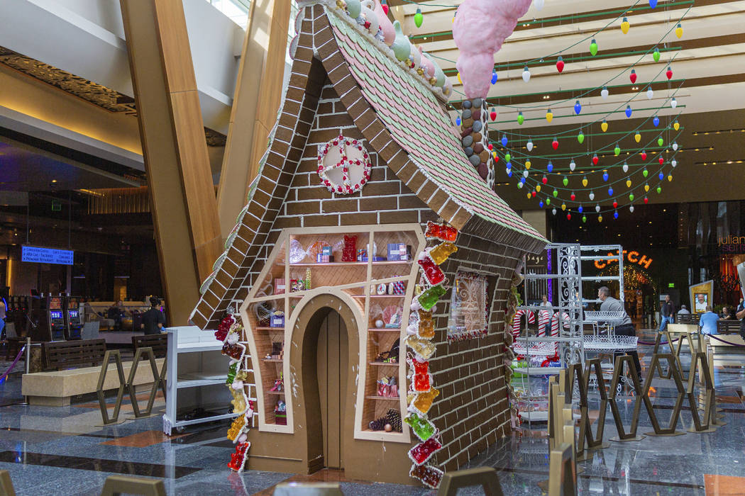 A giant gingerbread house in underway made by Aria Patisserie pastry chefs in the lobby of the ...