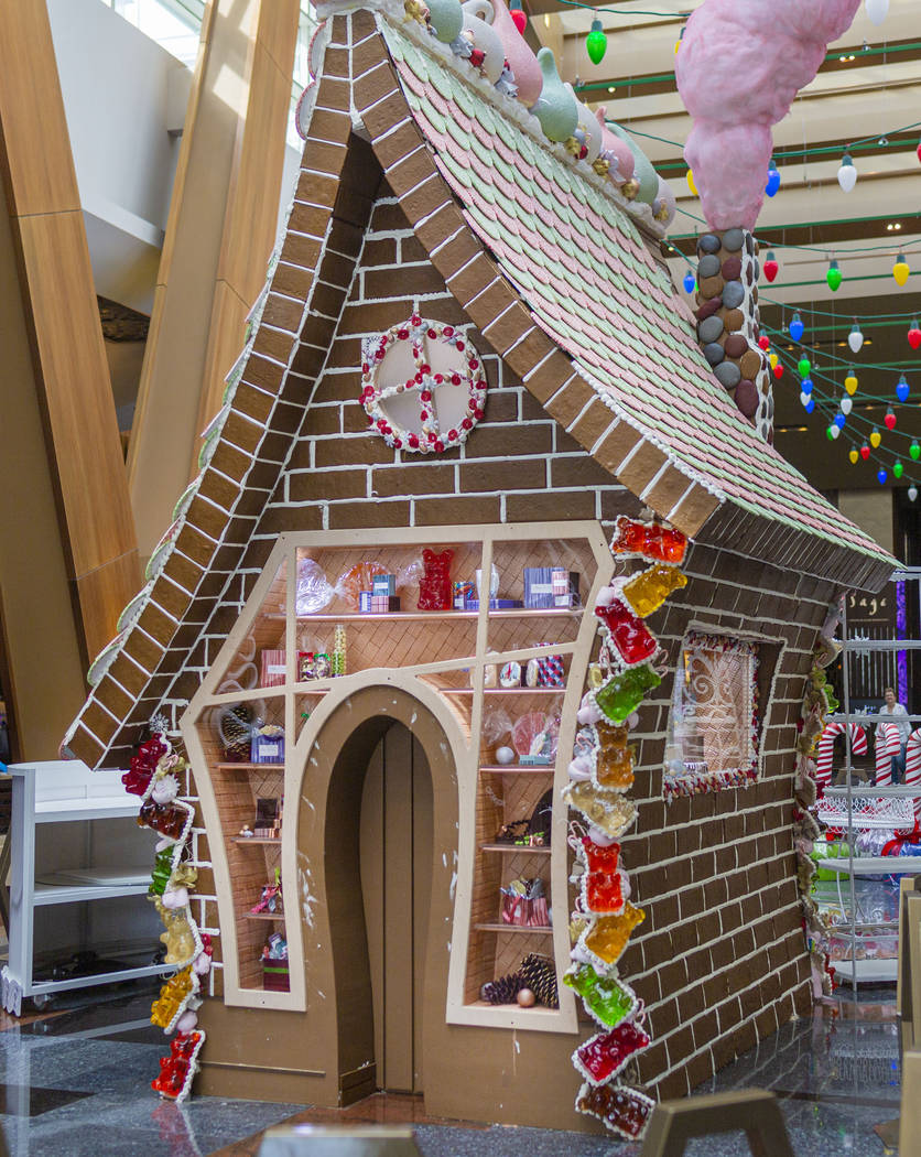 A giant gingerbread house in underway made by Aria Patisserie pastry chefs in the lobby of the ...