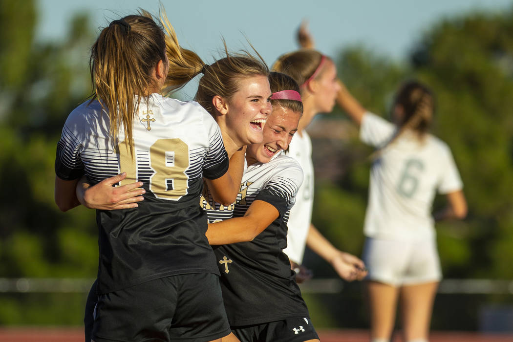 Faith Lutheran's Amelia McManus (20, center) celebrates a goal with teammates Addy Radwanski (1 ...