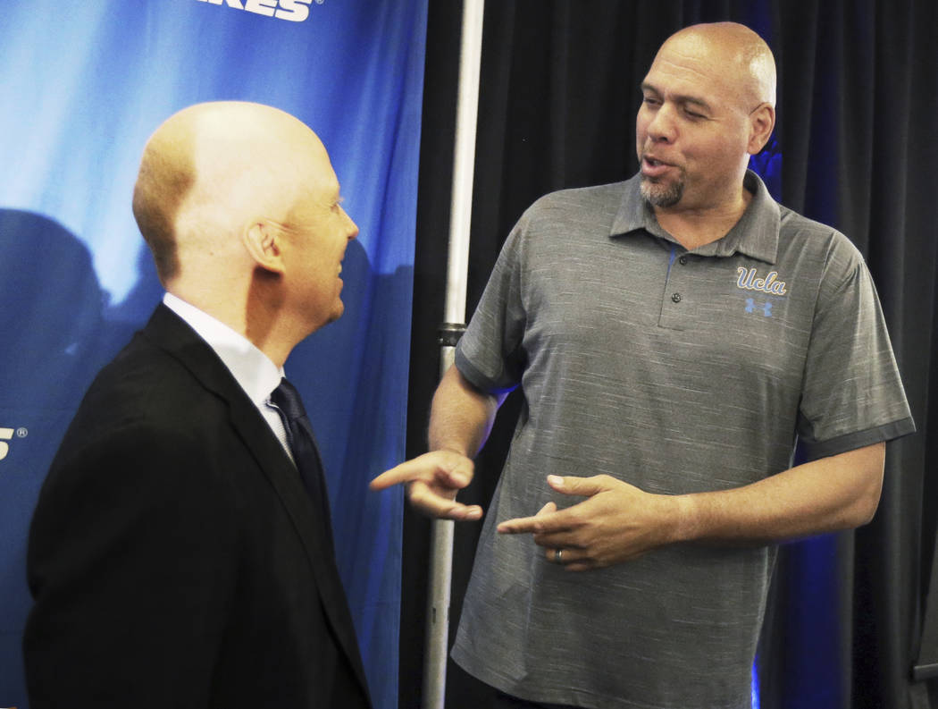 Mick Cronin, left, chats with former UCLA and NBA star Tracy Murray after Cronin was introduced ...