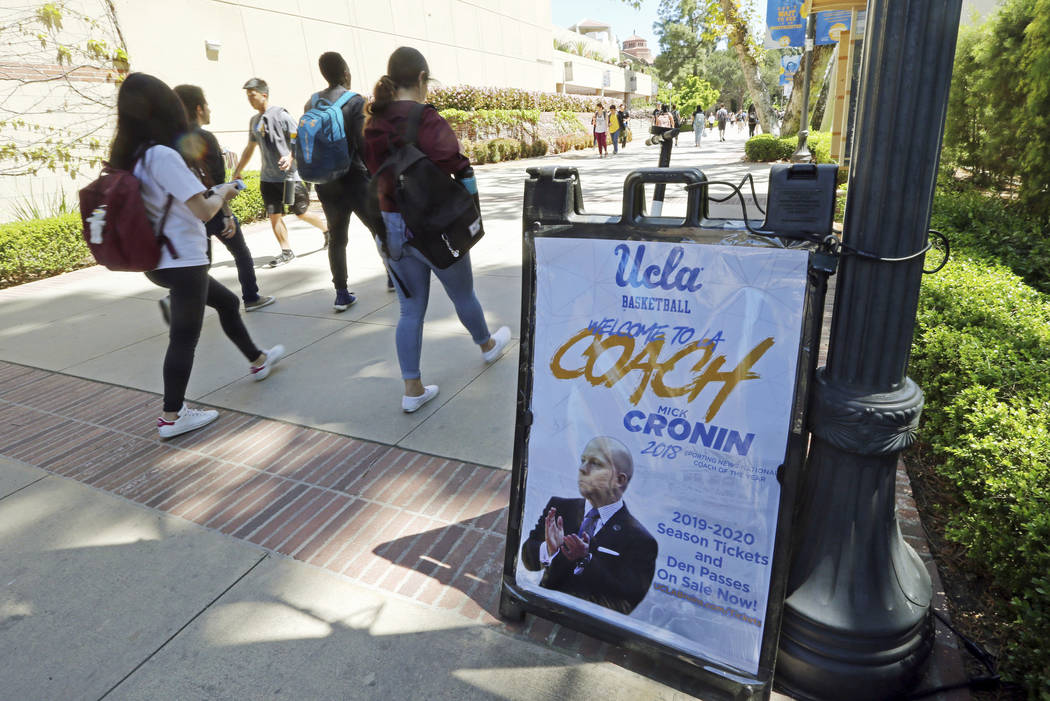 A sign promoting new head basketball coach Mick Cronin and the upcoming basketball season is se ...