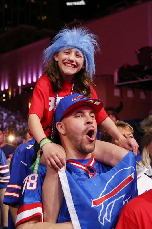 Fans cheer on the main stage during the second round of the NFL football draft, Friday, April 2 ...