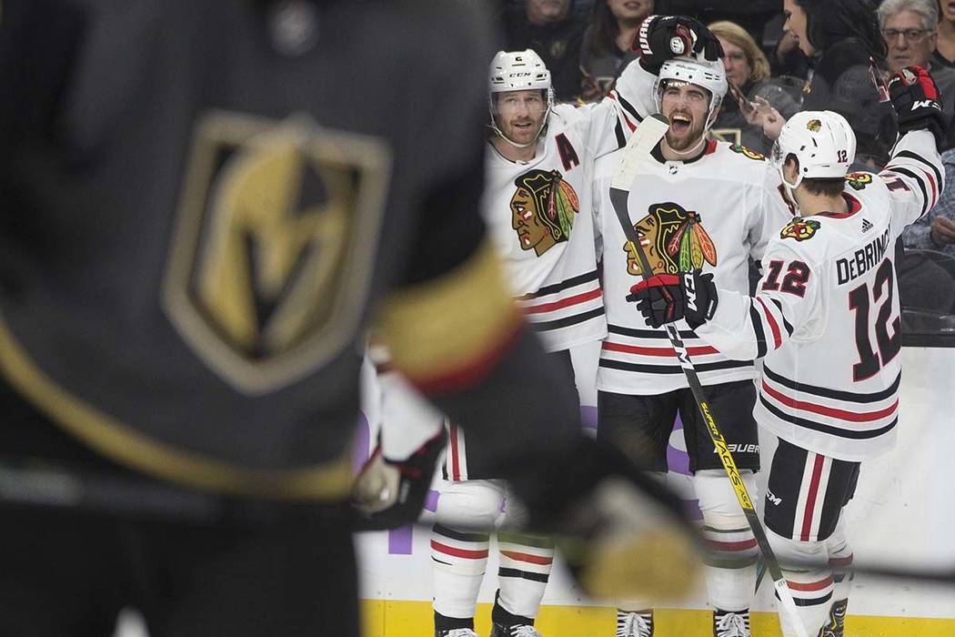 Chicago Blackhawks defenseman Erik Gustafsson, second from right, celebrates with Chicago Black ...