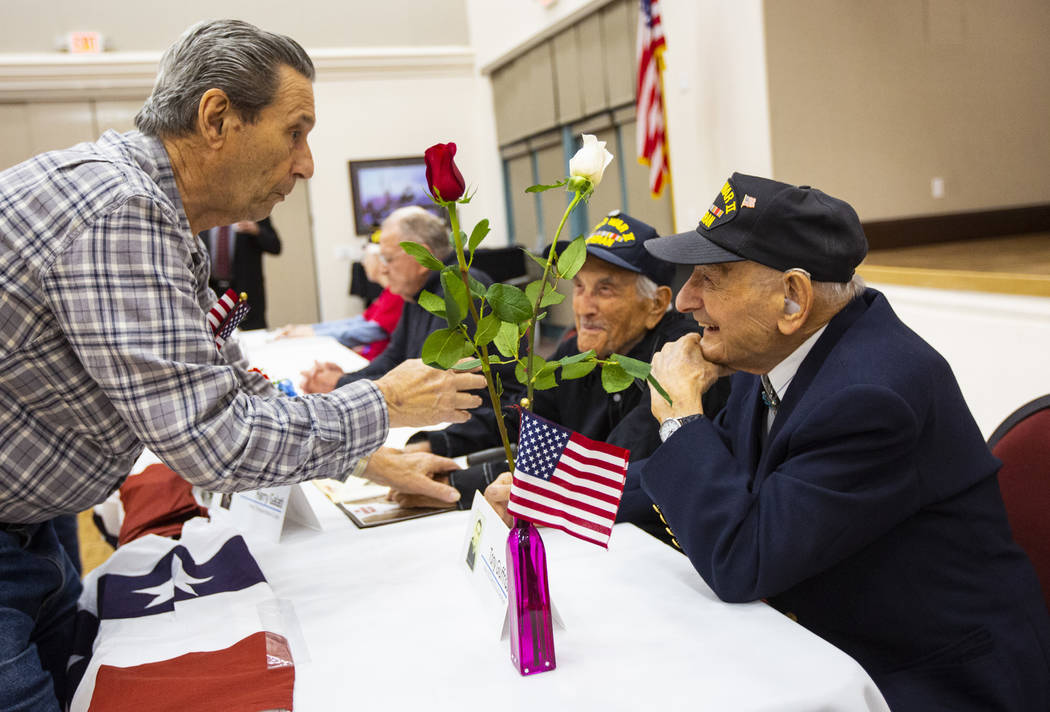 Korean War veteran Sammy Liguori, left, talks with World War II veterans Harry Galati, center, ...
