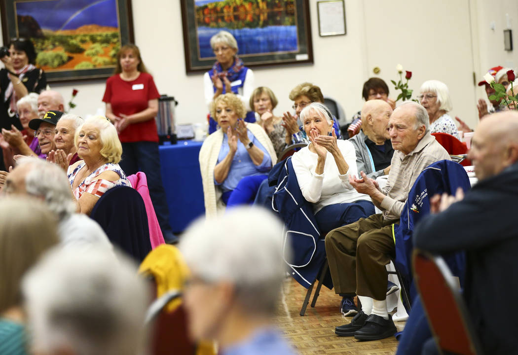 Attendees clap during an event honoring World War II veterans at the Desert Vista Community Cen ...