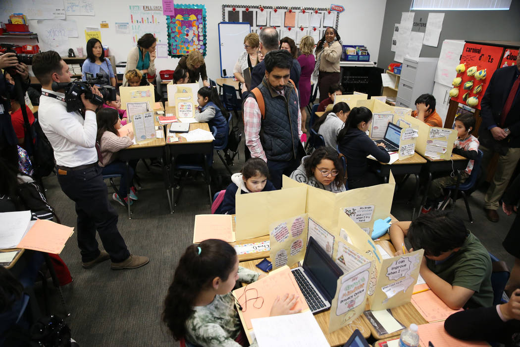 Educators including Sal Khan, center, founder of Khan Academy, tour of a classroom at Crestwood ...