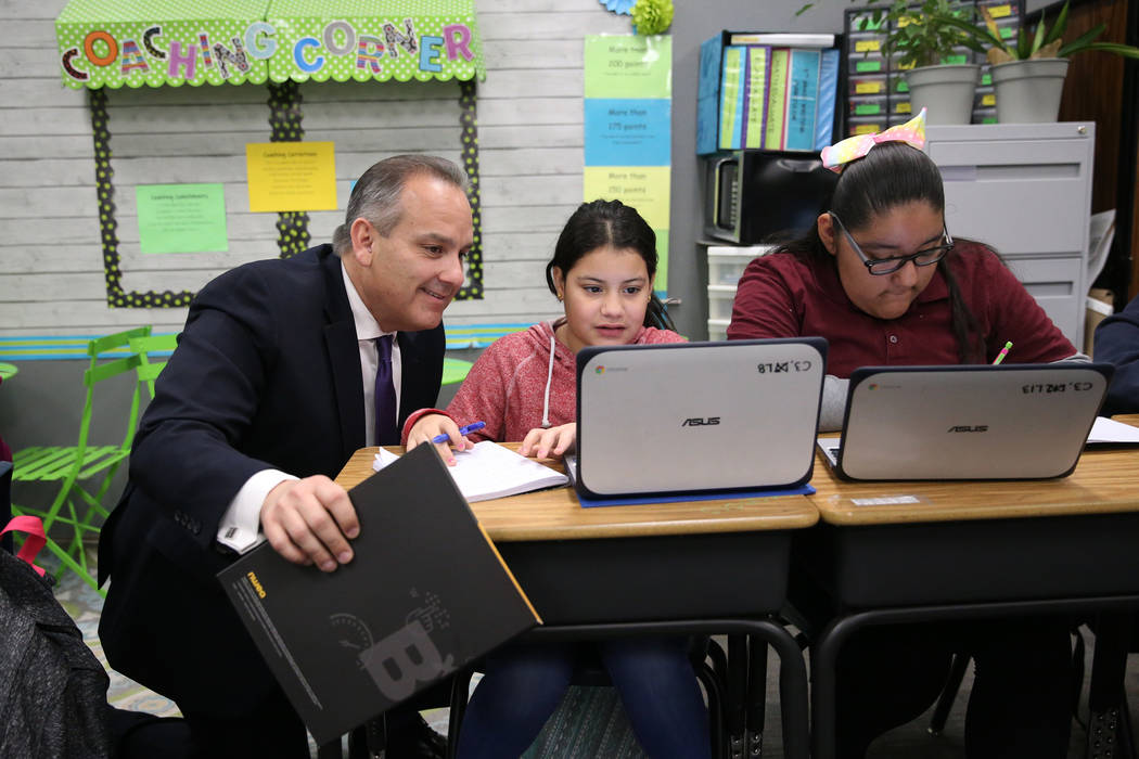 Clark County School District Superintendent Jesus Jara, from left, looks at the work by fifth-g ...
