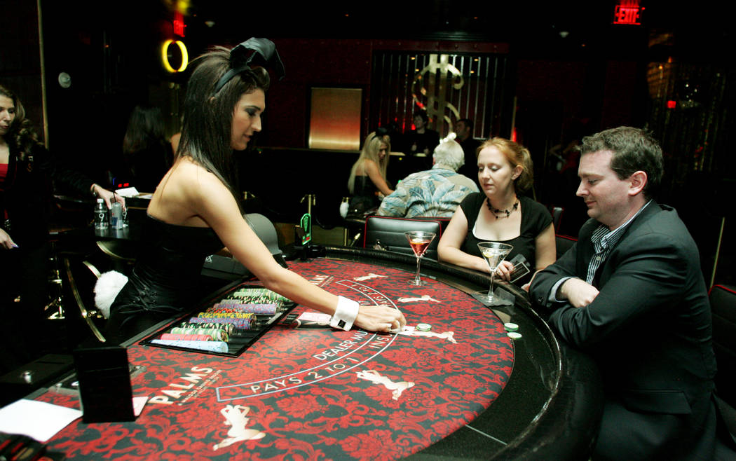 Playboy Bunny dealer Jessica Pagnoni, left, gives blackjack player Steve Lockett of Ashville, N ...