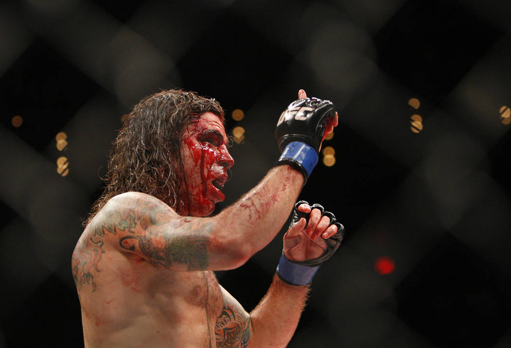 Ultimate Fighting Championship fighter Clay Guida, his face bloodied, faces opponent Diego Sanc ...