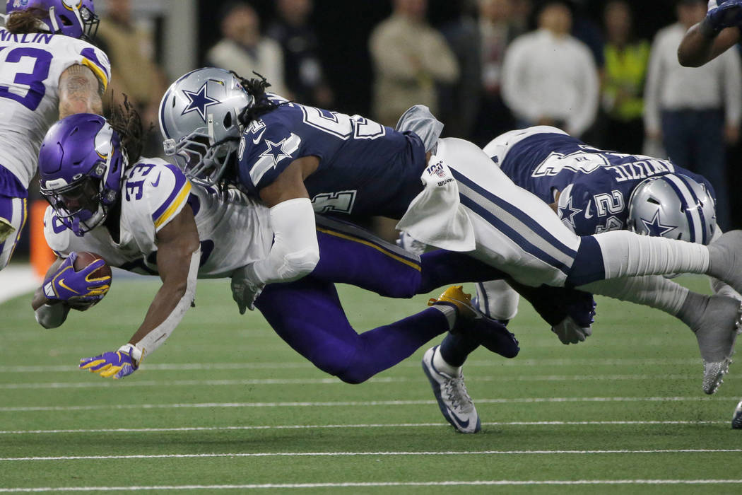 Minnesota Vikings running back Dalvin Cook (33) is tackled by Dallas Cowboys middle linebacker ...