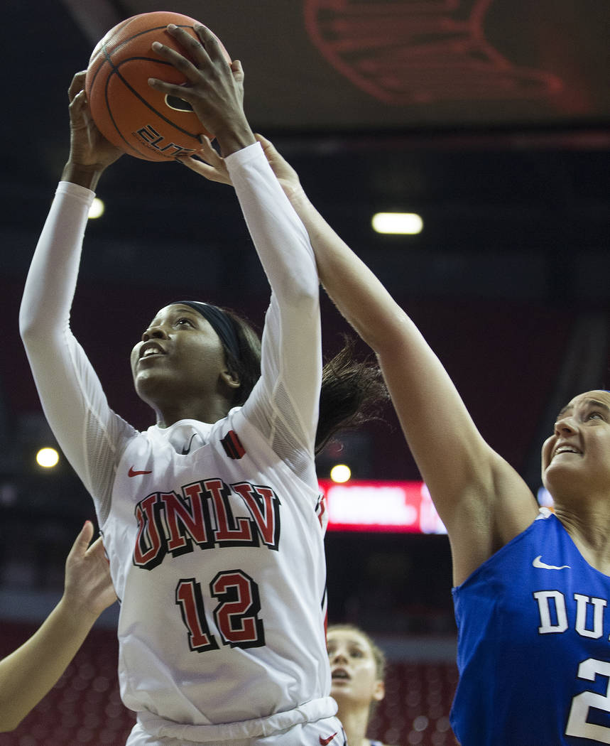 UNLV Lady Rebels forward Anna Blount (12) drives past Duke Blue Devils guard Haley Gorecki (2) ...