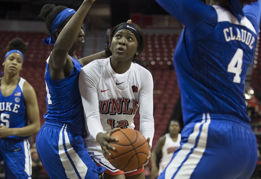 UNLV Lady Rebels forward Anna Blount (12) drives past Duke Blue Devils forward Onome Akinbode-J ...