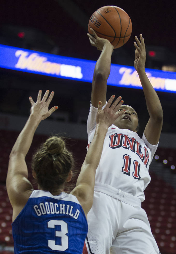 UNLV Lady Rebels guard Justice Ethridge (11) shoots over Duke Blue Devils guard Miela Goodchild ...