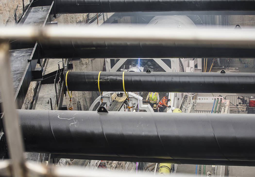 The tunnel boring machine begins work at the future location of one of the underground people m ...