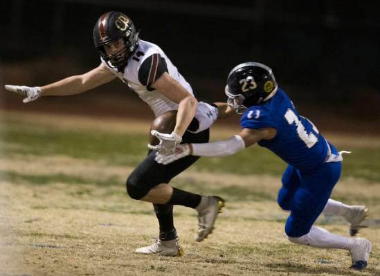 Faith Lutheran senior wide receiver Peyton Thornton (14) turns up field past Desert Pines senio ...
