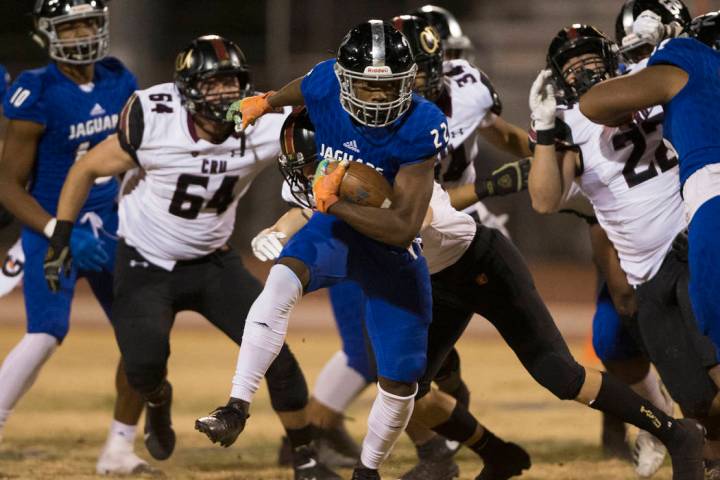 Desert Pines sophomore running back Javontae Barnes (22) breaks a big run past Faith Lutheran s ...