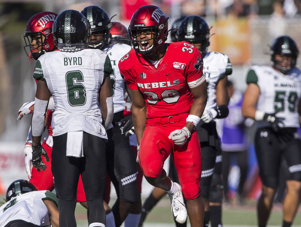 UNLV Rebels defensive back Sir Oliver Everett (33) celebrates in front of Hawaii Warriors wide ...