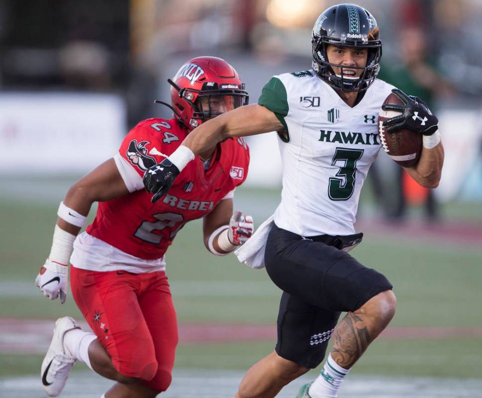 Hawaii Warriors wide receiver Jason-Matthew Sharsh (3) sprints down the sideline past UNLV Rebe ...