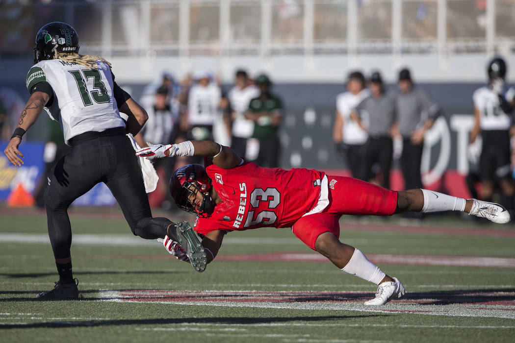 UNLV Rebels linebacker Farrell Hester II (53) dives to try and tackle Hawaii Warriors quarterba ...