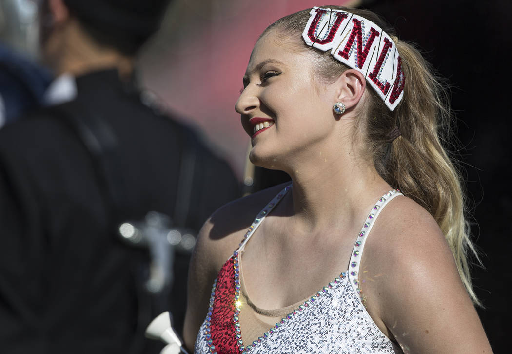 A UNLV baton twirler cheers for the Rebels before the start of their NCAA football game with Ha ...