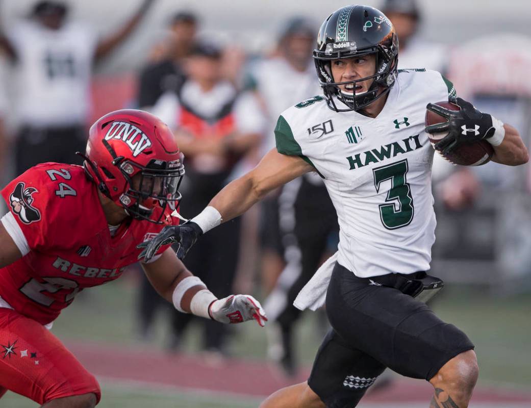 Hawaii Warriors wide receiver Jason-Matthew Sharsh (3) breaks a big run past UNLV Rebels defens ...