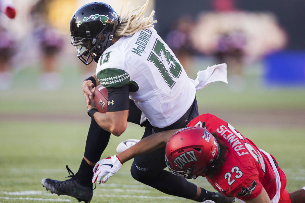 Hawaii Warriors quarterback Cole McDonald (13) is tackled by UNLV Rebels defensive back Greg Fr ...