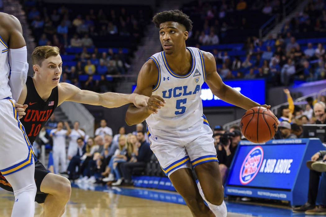 UCLA Bruins guard Chris Smith (5) drives the ball to to the outside during a college basketball ...