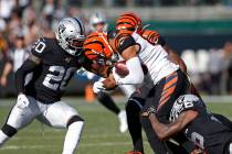 Cincinnati Bengals wide receiver Tyler Boyd is stopped with the ball by Oakland Raiders cornerb ...