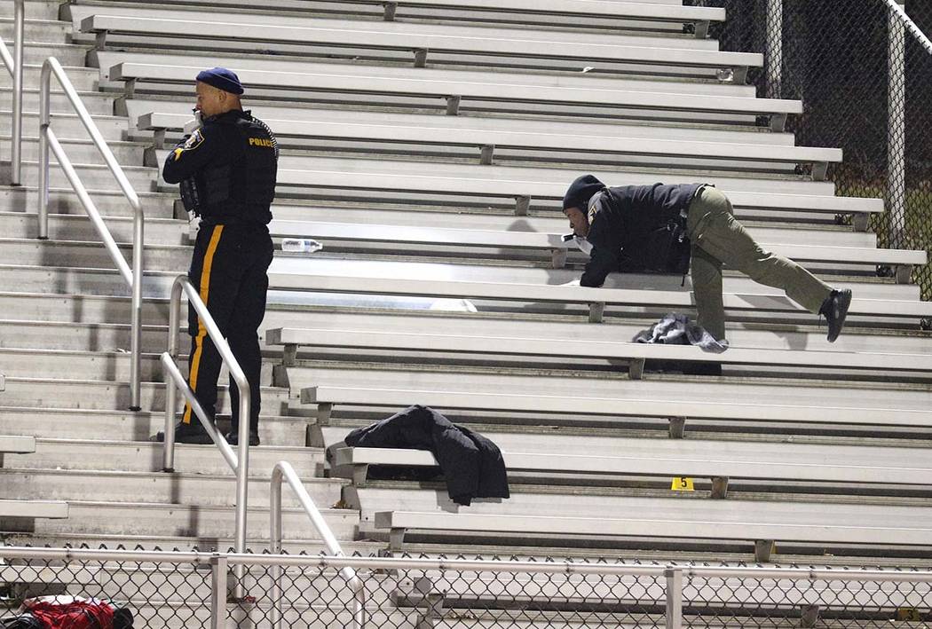 Pleasantville police search the stands after a shooting during a football game at Pleasantville ...