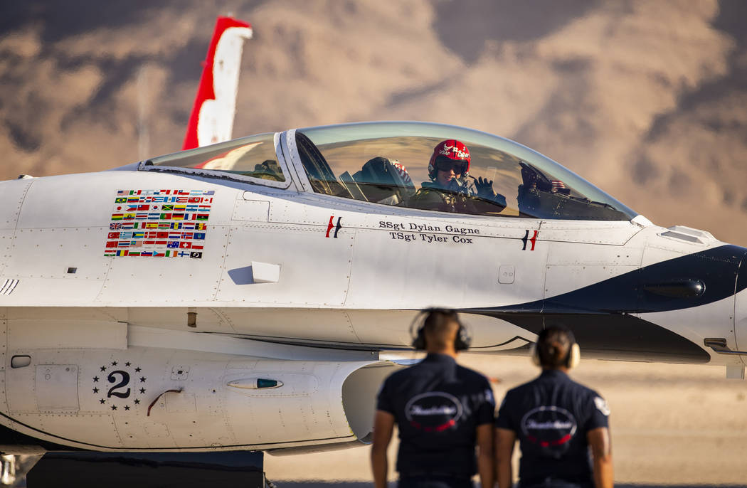 Lt. Col. John Caldwell with the U.S. Air Force Thunderbirds waves to the crowd as he taxis his ...