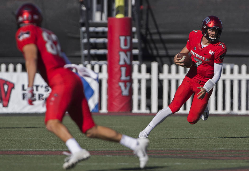 UNLV Rebels quarterback Kenyon Oblad (7) scrambles in the first quarter during their NCAA footb ...