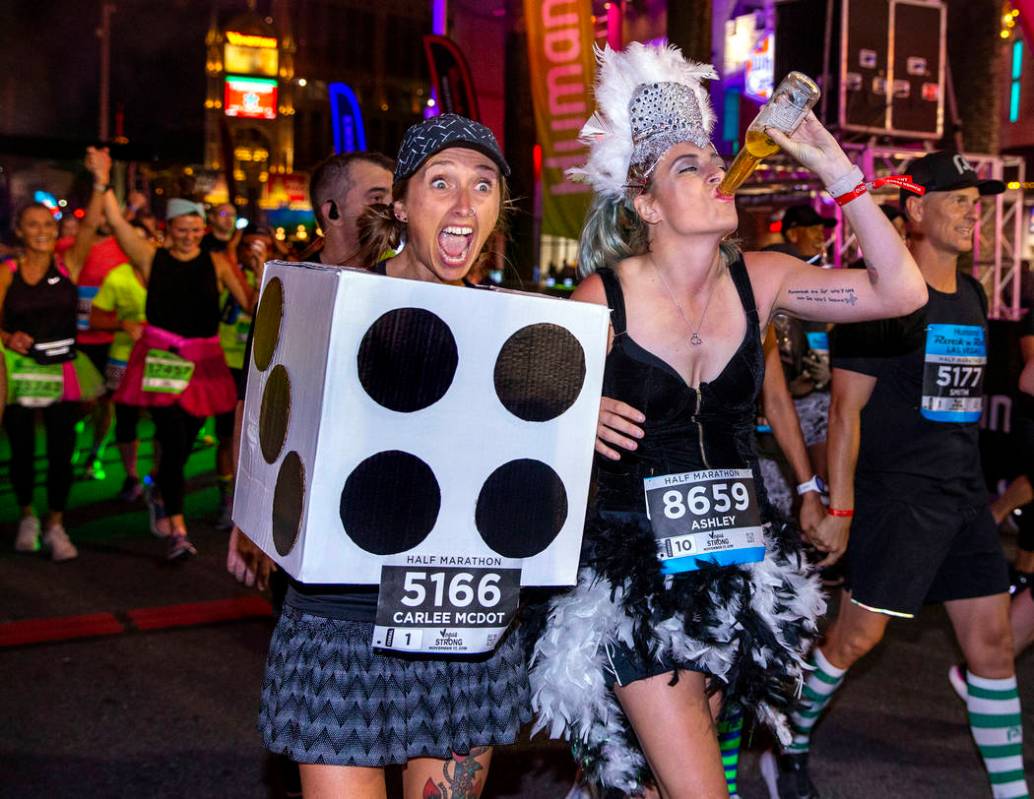 Carlee McDot, left, and Ashley Chroninger celebrate their half marathon finish during the Las V ...