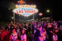 Runners are married in a mass wedding at the Las Vegas sign at the Rock ÕnÕ Roll Mara ...