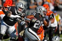 Oakland Raiders running back Josh Jacobs carries the ball during the first half of an NFL footb ...