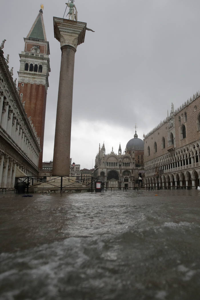 Water starts coming in as the city awakes, in Venice, Italy, Sunday, Nov. 17, 2019. Venetians a ...